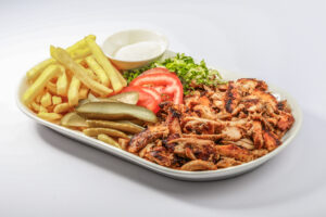Chicken Shawarma plate with salad, fries served in a dish isolated on grey background side view of arabian fastfood