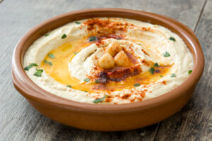 chickpea-hummus-bowl-wooden-table
