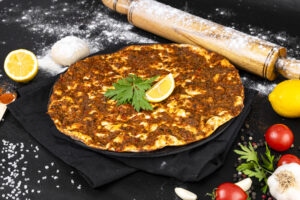 famous-turkish-lahmacun-pita-black-background-with-parsley-lemon
