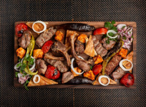 assorted meat kebab with onions herbs and grilled vegetables