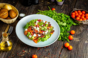 plate-salad-with-cheese-baked-pepper-herbs-vegetables-sauce