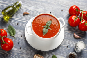 Tomato soup with basil in a bowl.