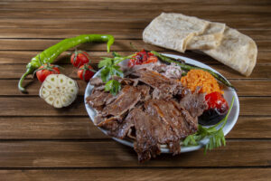 Turkish doner kebab with vegetable and over vintage wooden table